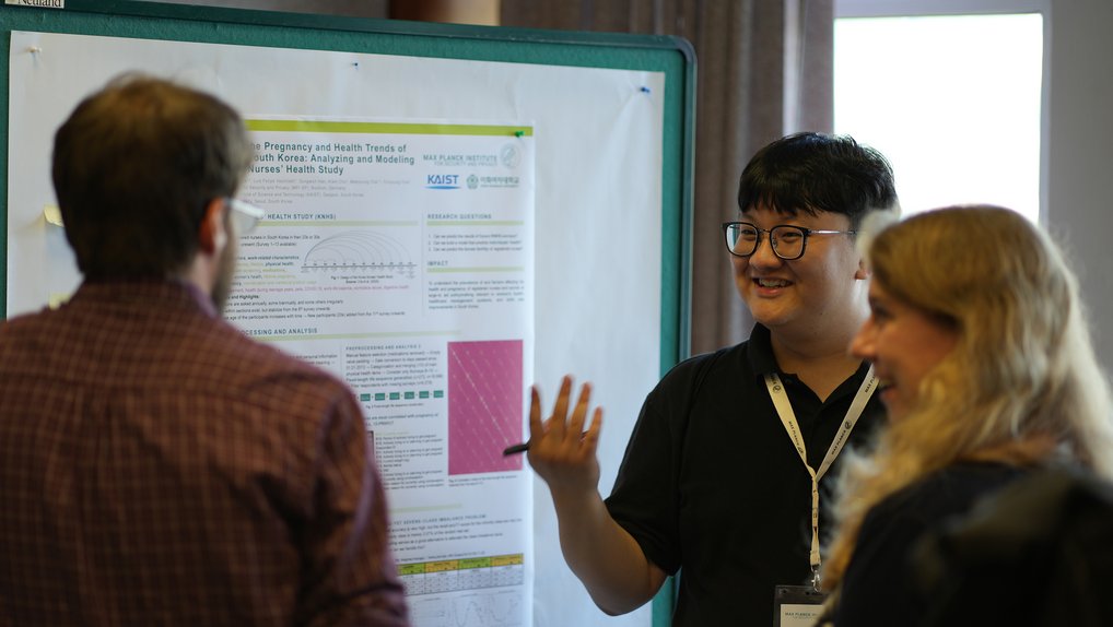 Research discussion in front of a poster
