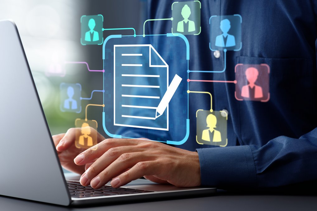 Person typing on a laptop with a digital document icon displayed at the center of the screen, connected by lines to multiple user profile icons. The illustration represents electronic document management, digital collaboration, workflow automation, or online document sharing.