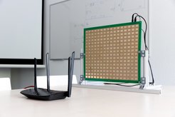 The intelligent reflecting surface IRShield is positioned next to a Wi-Fi router for obfuscation of the environment-dependent wireless channel.