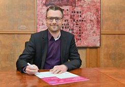 Axel Degenhardt, the Head of Administration, signing the Charter